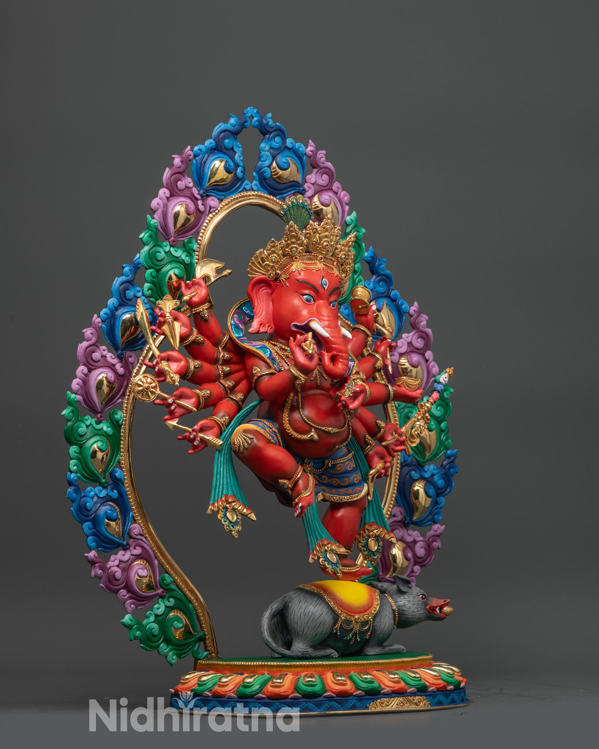 Side angle Rakta Ganesh copper statue with twelve arms and flowing robes
