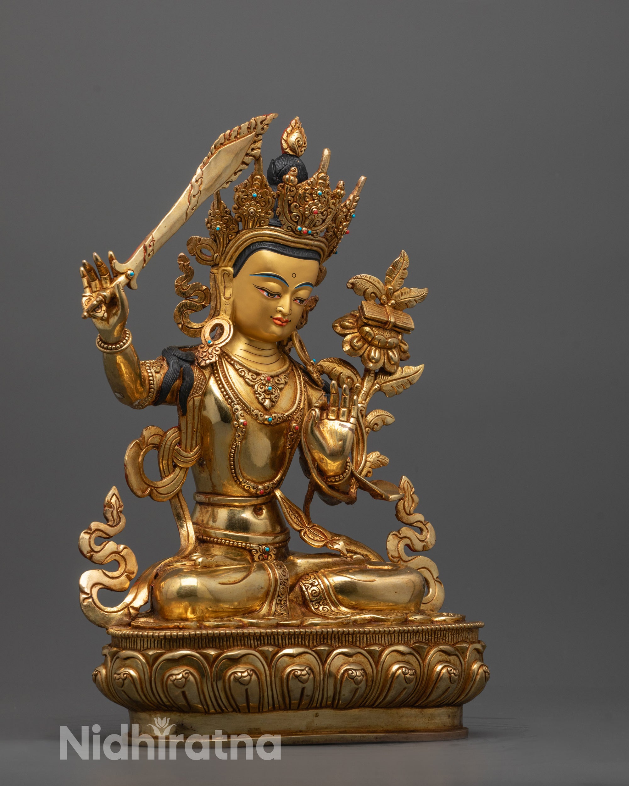 Side angle close-up of Manjushri Statue showing detailed 24k fire gold gilding