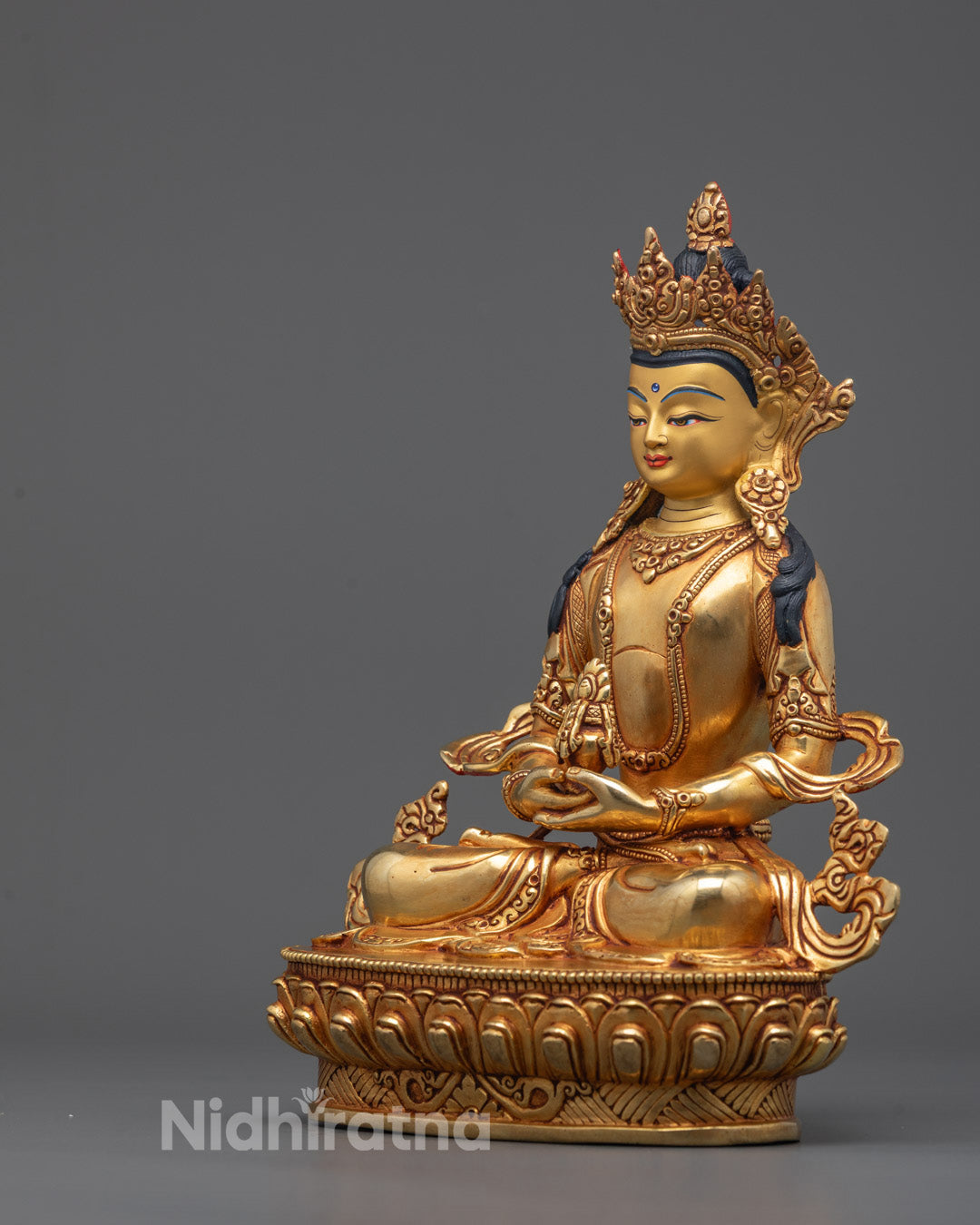 Side angle of Amitayus statue showing flowing robes and ornate jewelry details
