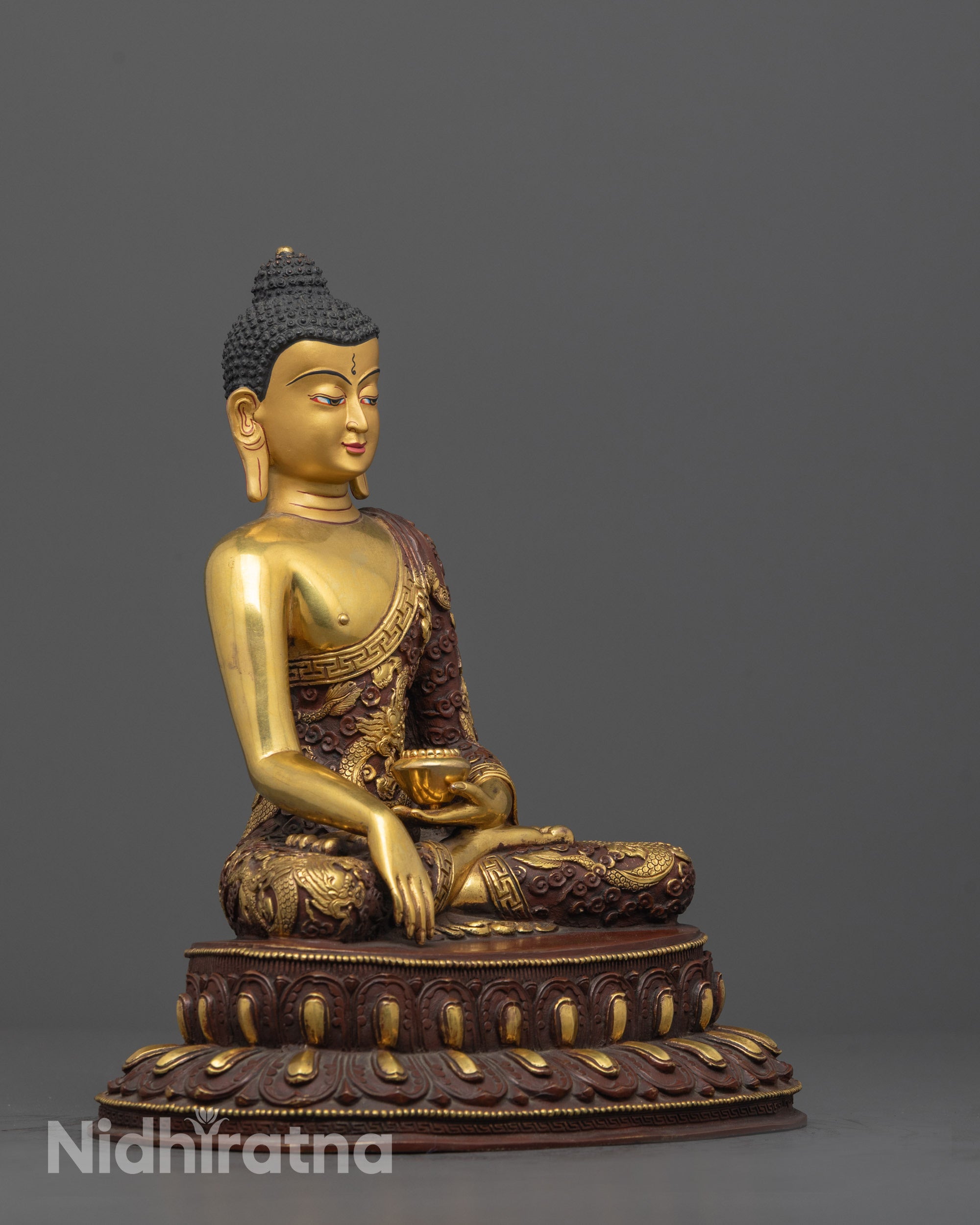 Side angle of Buddha holding alms bowl in bhumisparsa mudra on lotus throne