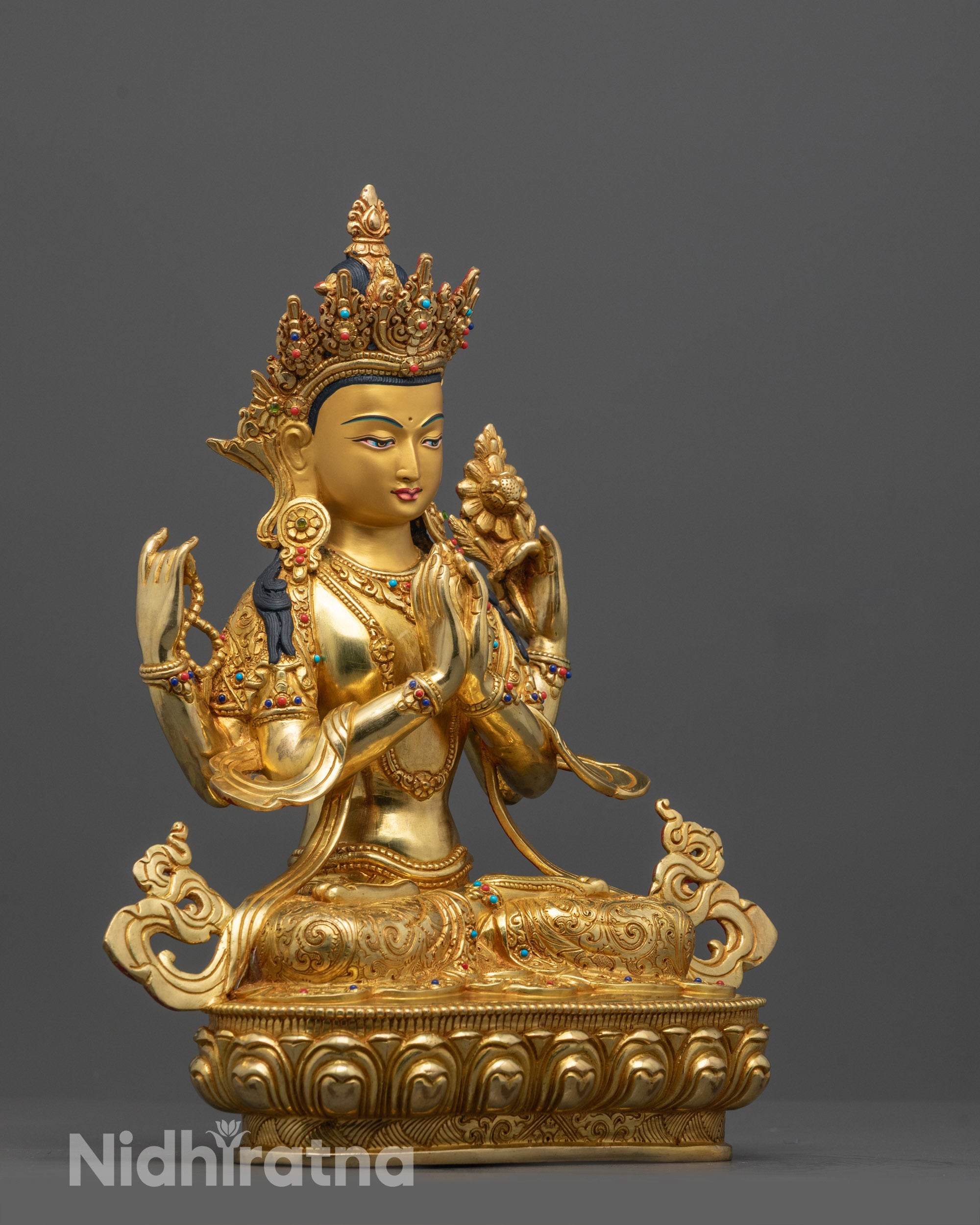 Side angle of Chenrezig statue highlighting lotus throne, detailed robes, and symbolic objects