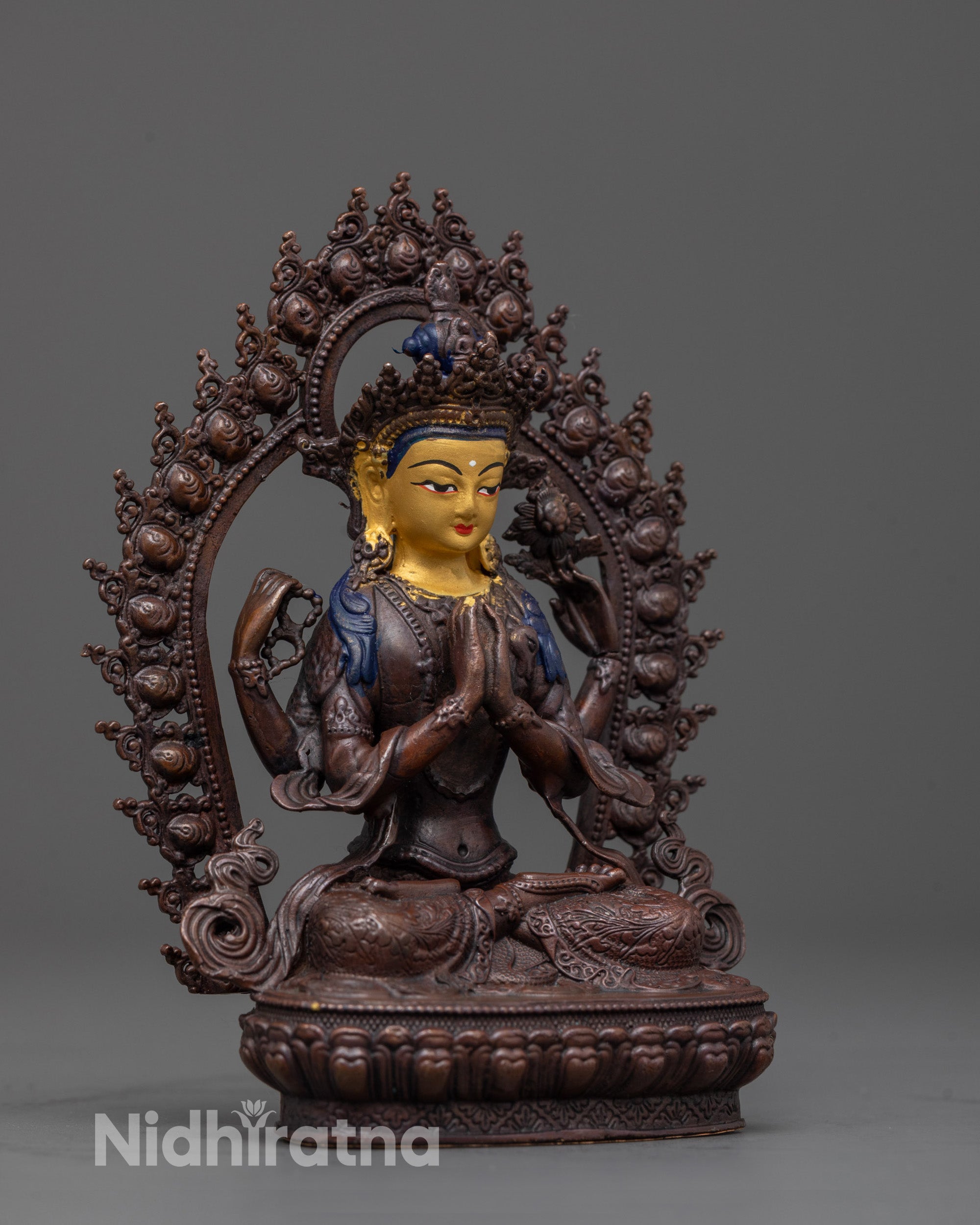 Side angle of Chenrezig statue holding wish fulfilling gem rosary and lotus in hand