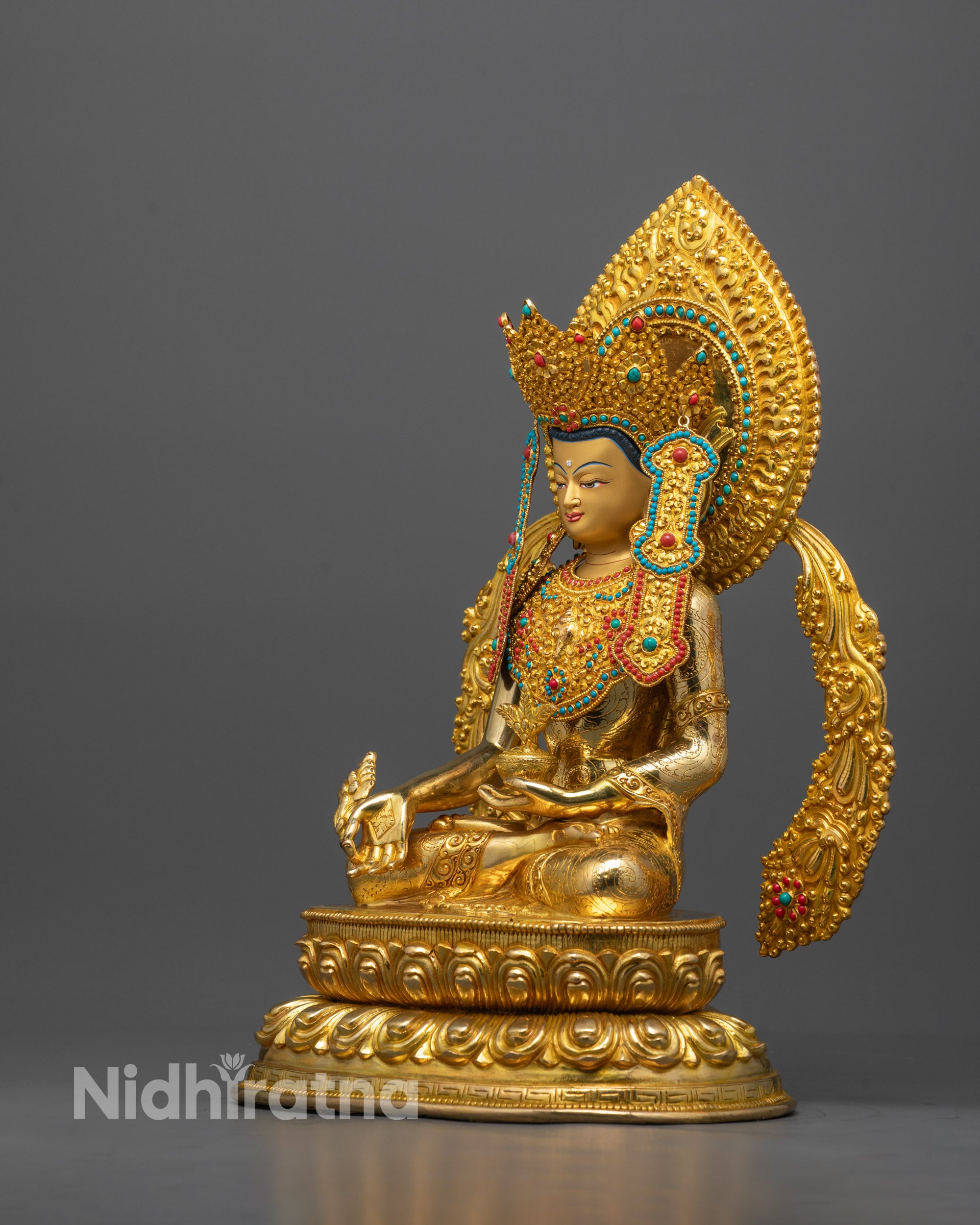 Side angle of Crown Medicine Buddha on lotus throne holding myrobalan plant