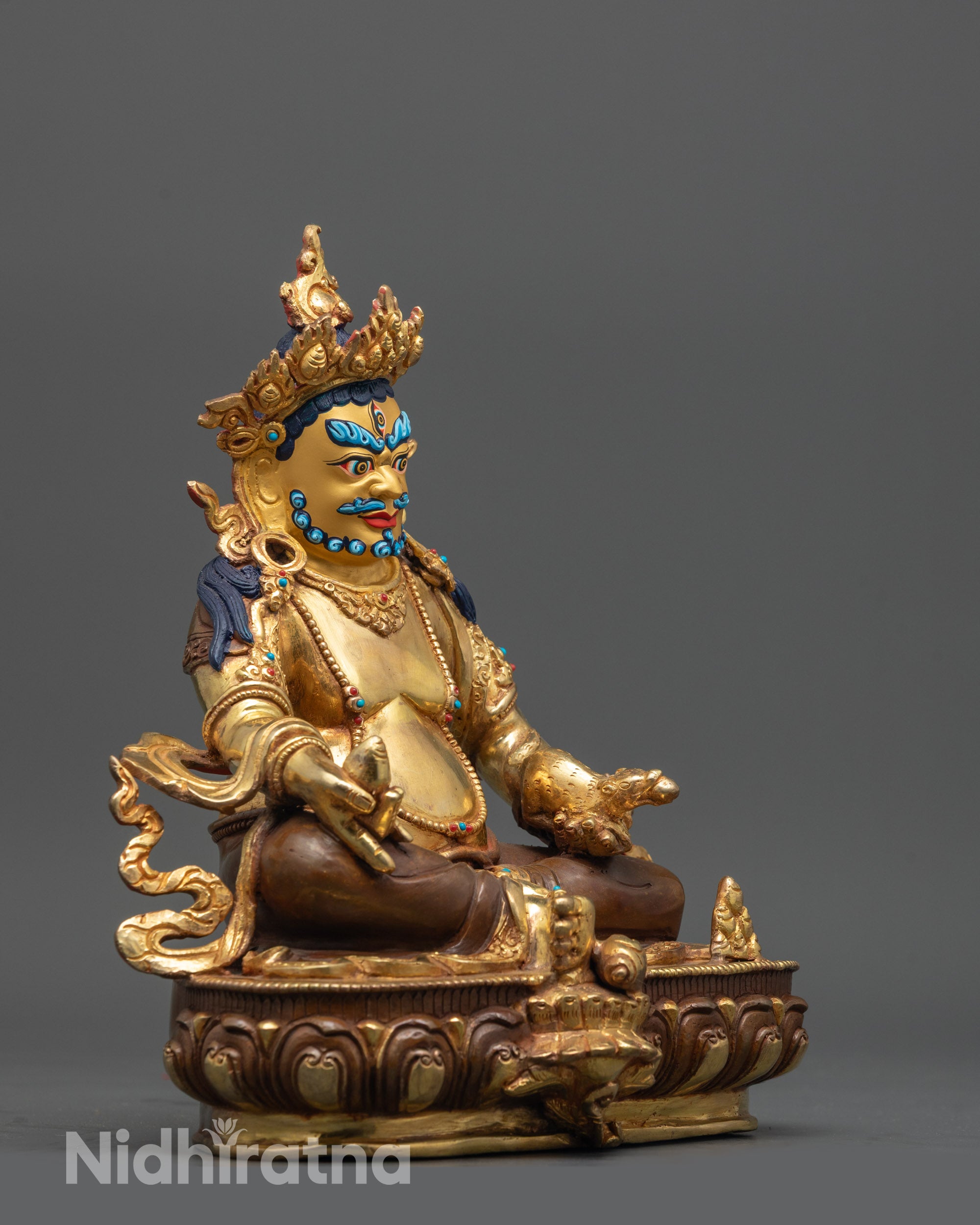 Side angle of Dzambhala Statue showing semi-precious stones on jewelry and crown