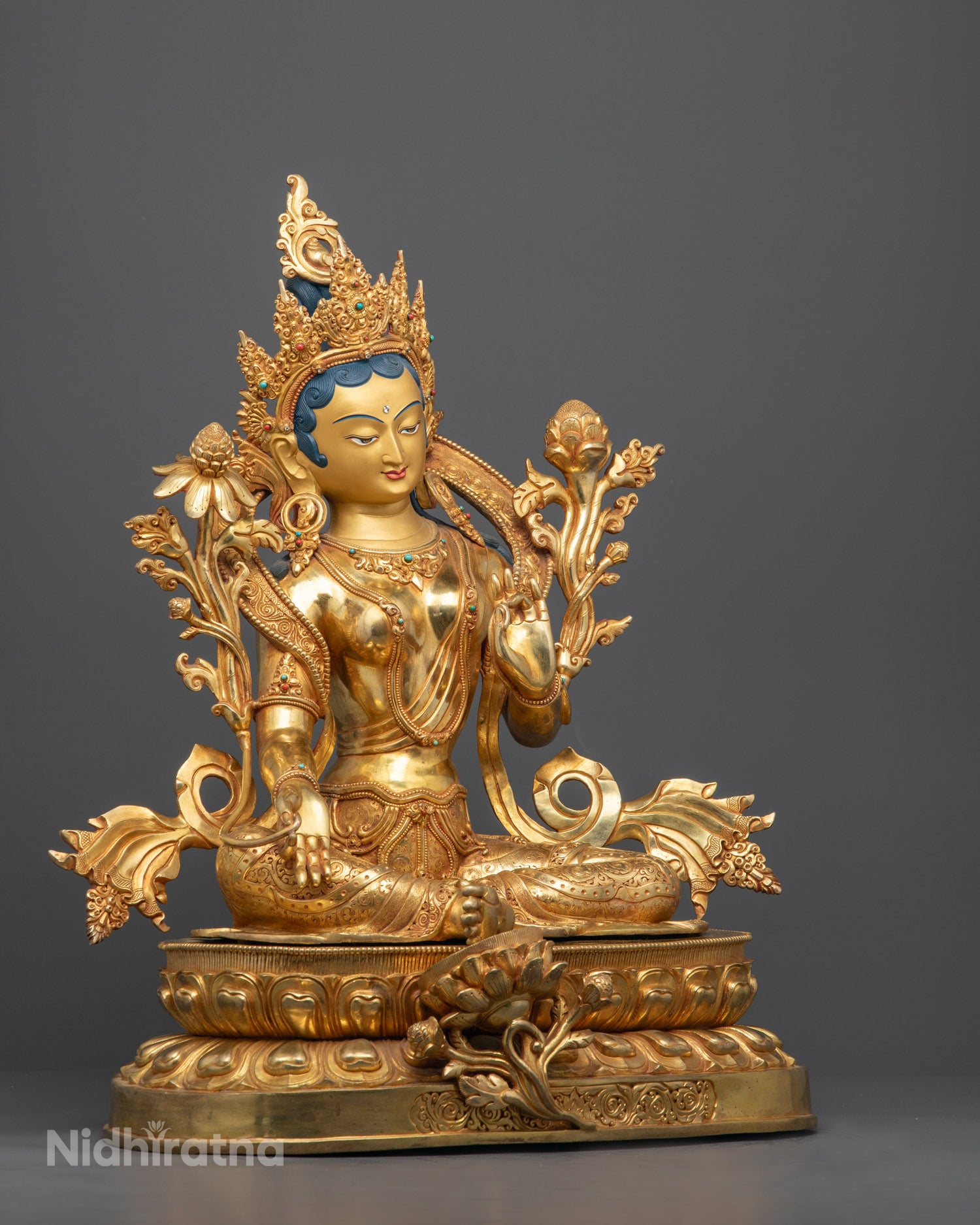 Side angle of Green Tara Statue showing flowing robe and lotus throne details

