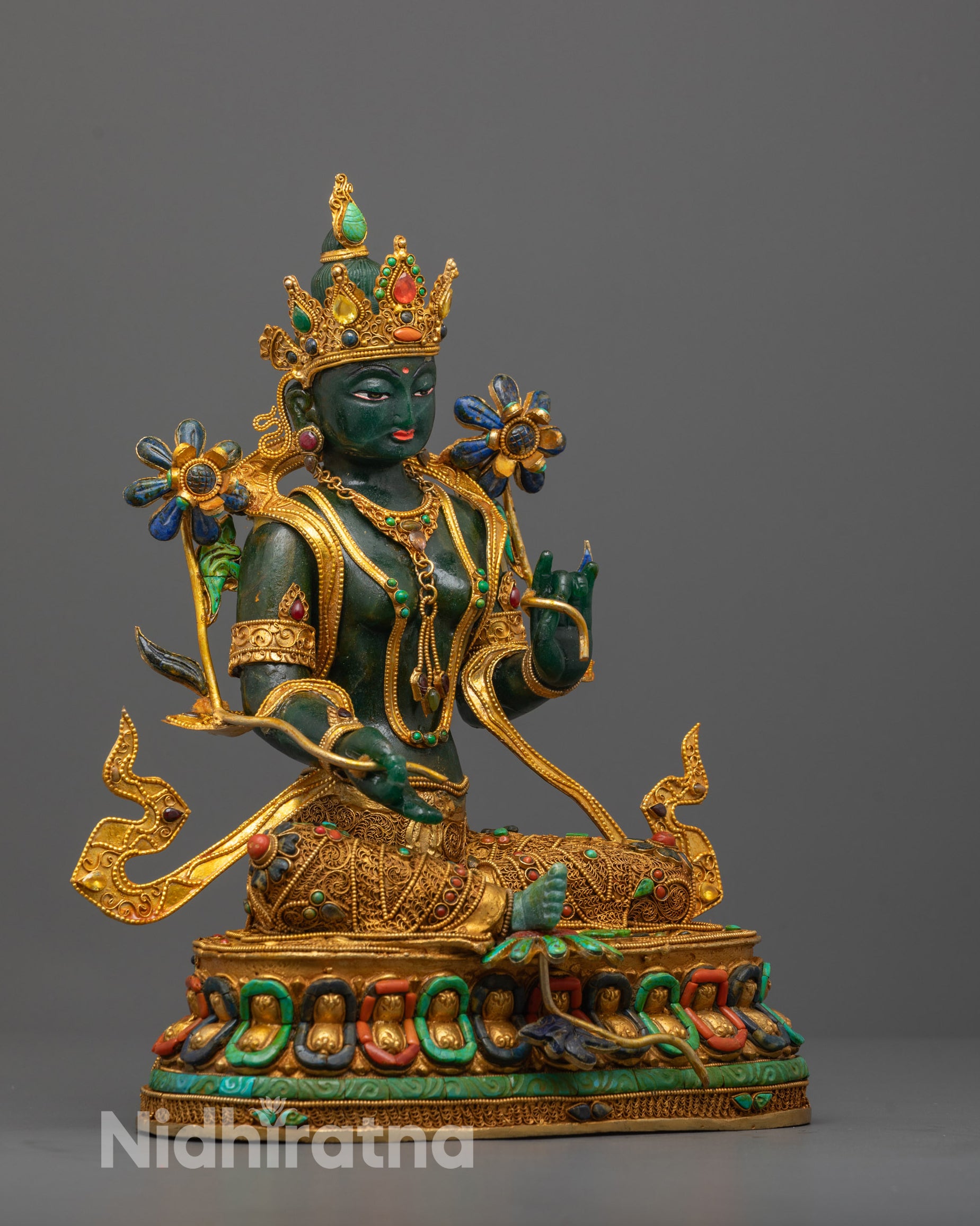 Side angle of Green Tara showing her extended right leg and delicate posture