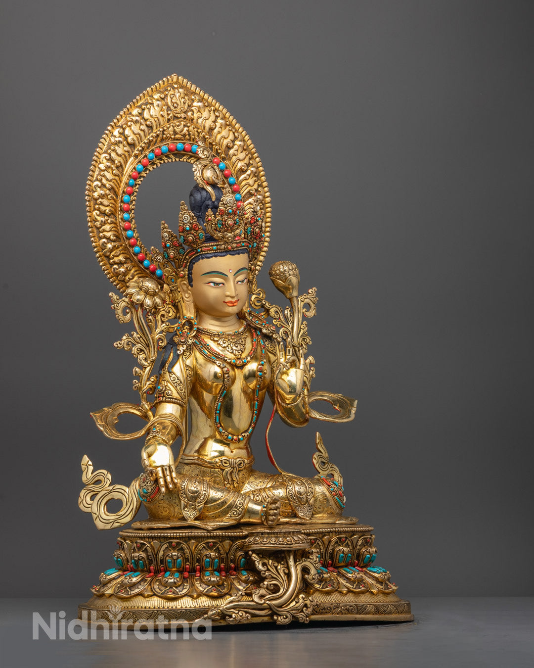 Side angle of Green Tara statue showing robe details and semi-precious stone adornments