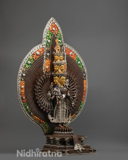 Side angle of Guan Yin statue with thousand arms and acrylic-colored halo motifs