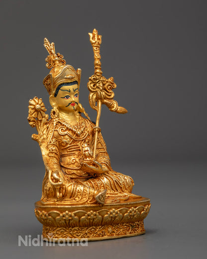 Side angle of Guru Menla statue showing Khaṭvāṅga trident and robe carvings