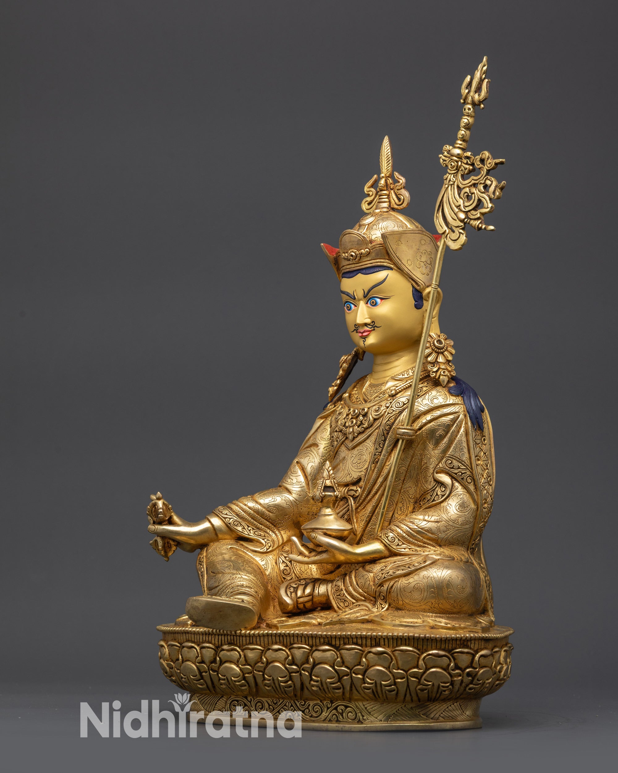 Side angle of Guru Rinpoche Statue showing dorje, skull cup, and trident