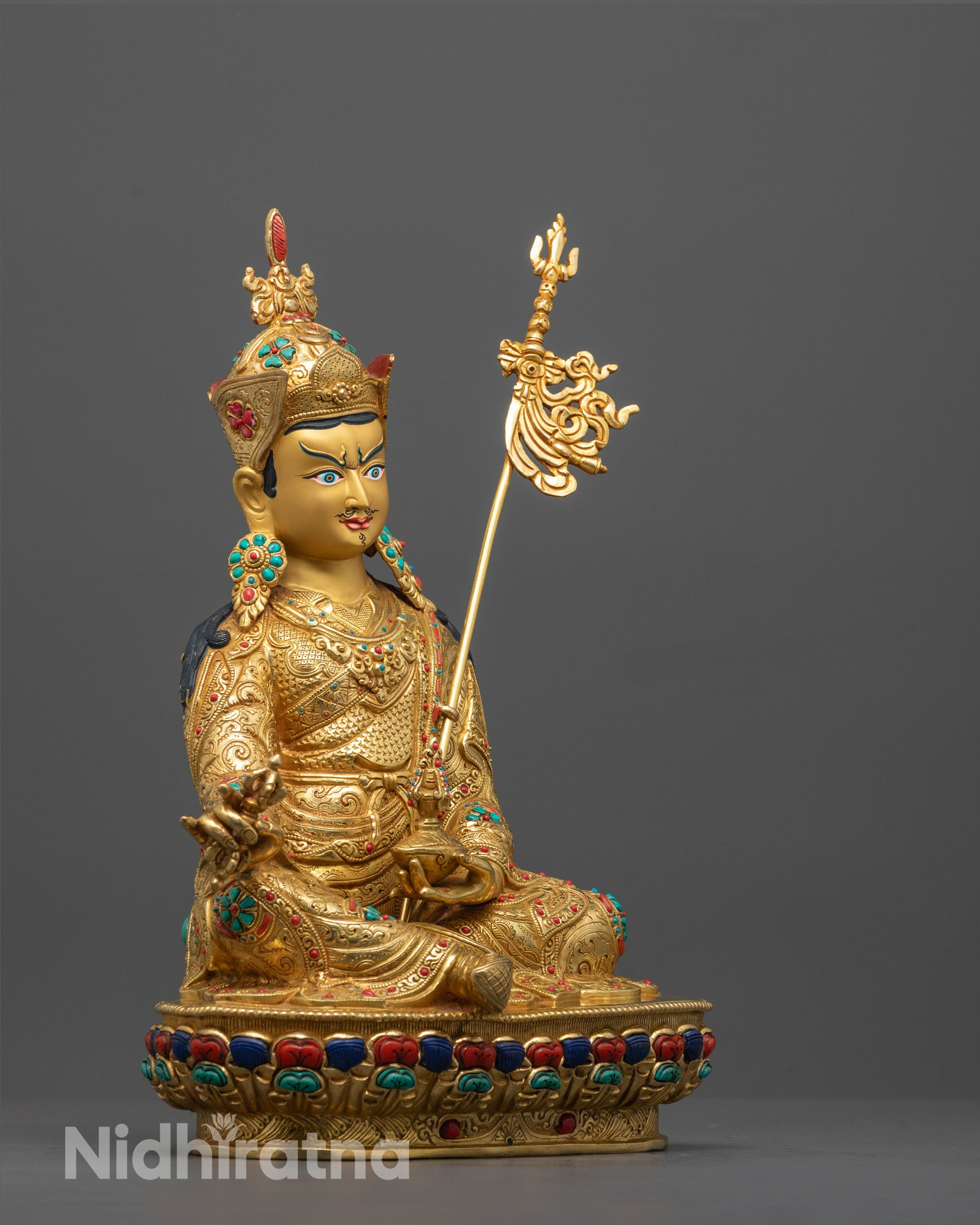 Side angle of Guru Rinpoche statue showing lotus seat, fire gilded copper base