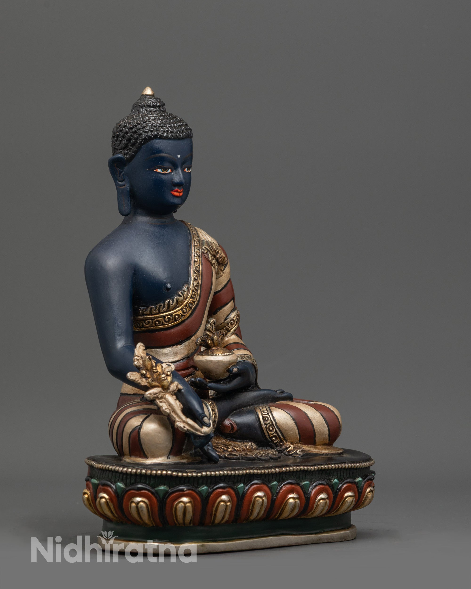 Side angle of Medicine Buddha Statue seated on painted lotus seat