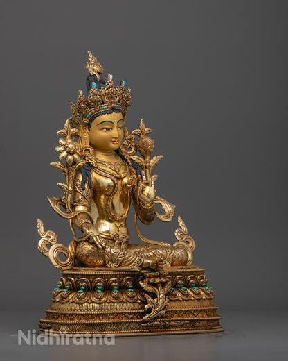 Side angle of Mother Tara statue showing fire-gilded body and detailed flowing robes, Buddhist deity