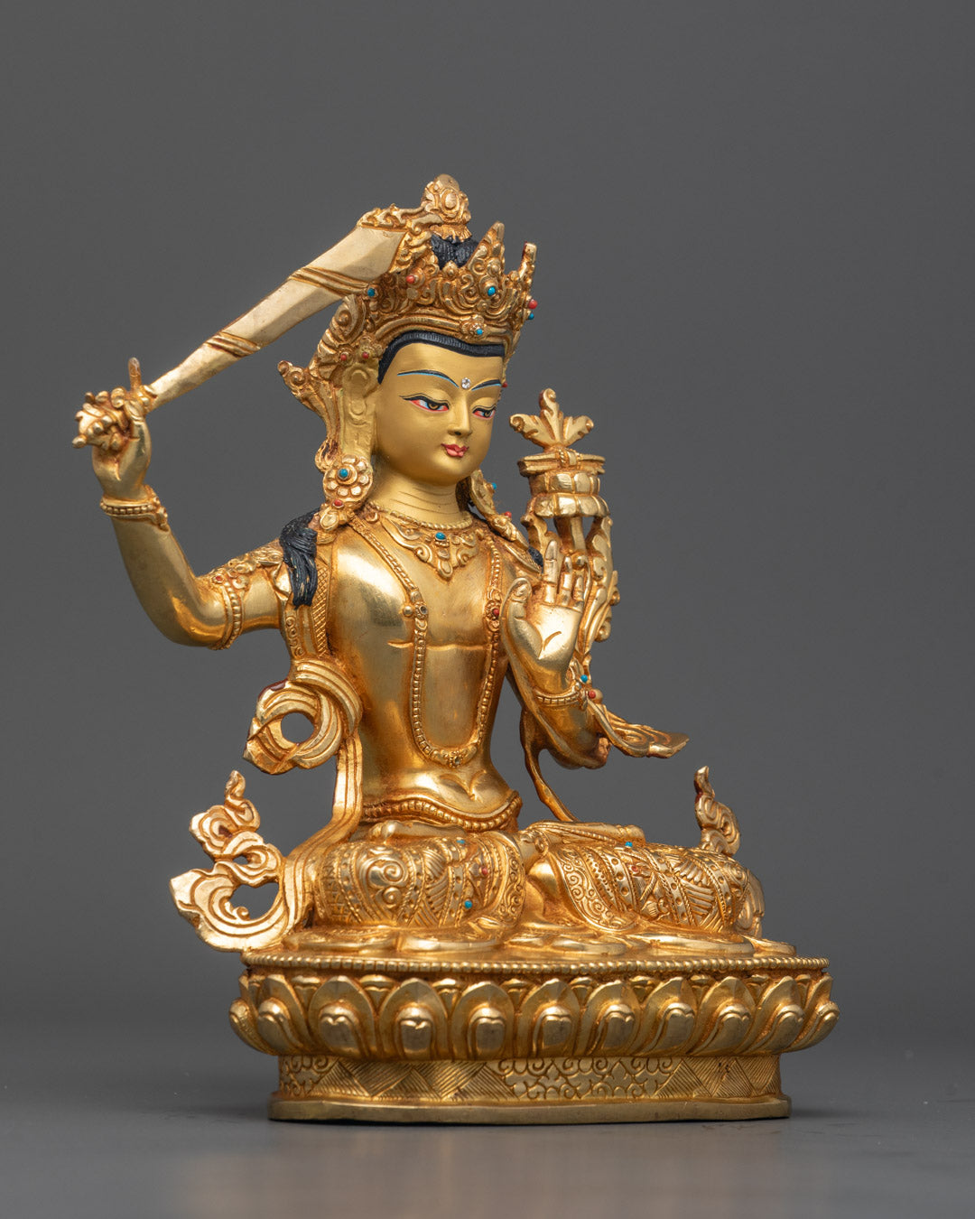 Side angle of Nepal Manjushri statue with detailed robe and 24K Gold Fire-gilded body