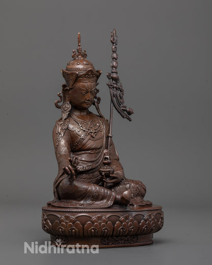 Side angle of Padmasambhava statue showing detailed robe patterns and semi-wrathful