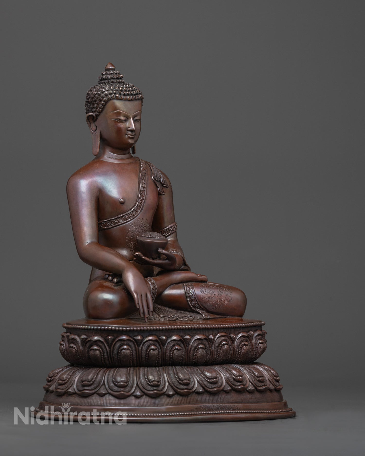 Side angle of Shakyamuni Buddha showing Patra bowl and detailed carvings