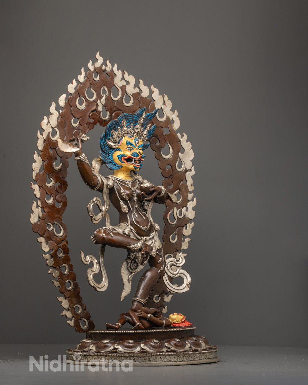 Side angle of Singha Mukha Dakini Statue highlighting silver-plated finish