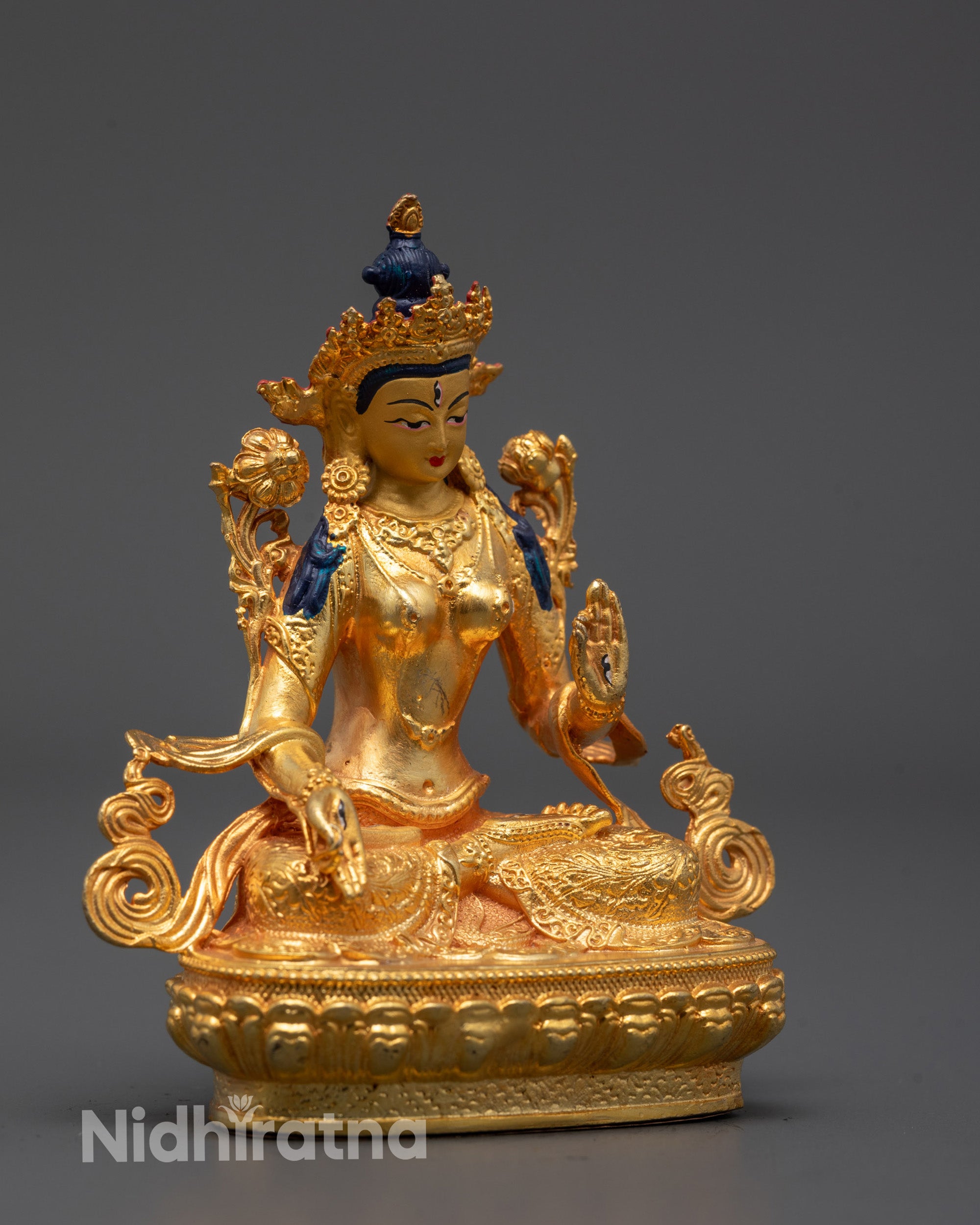 Side angle of Sita Tara statue seated in blessing mudra with gold-plated body and serene posture
