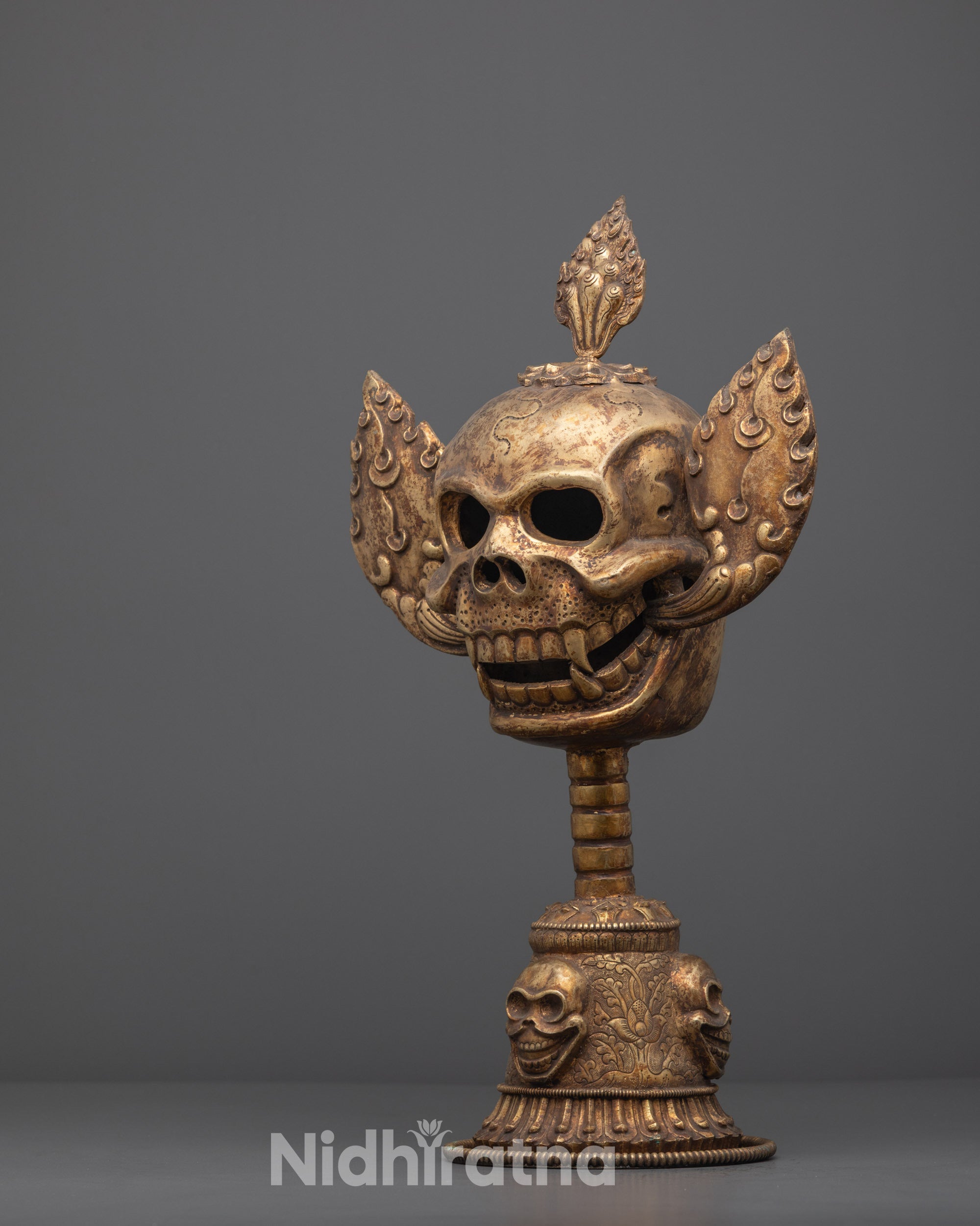 Side angle of Tibetan Citipati Skull Set showing detailed gold plating