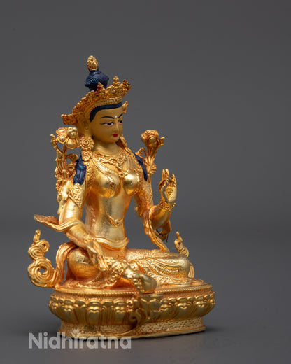 Side angle of Tibetan Green Tara statue seated in royal ease pose holding utpala flower