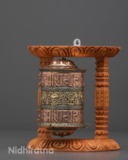 Side angle of Tibetan Prayer Wheel highlighting brass and carved wooden frame details