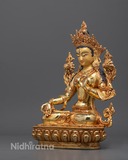 Side angle of White Tara Sculpture holding uptala flower, highlighting flowing robe details