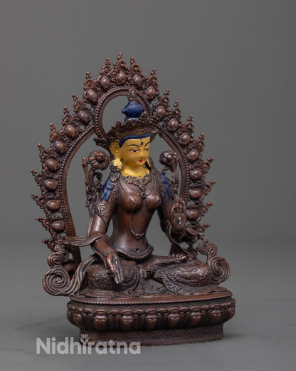 Side angle of White Tara Statue seated on lotus seat with glowing halo and earthy tones