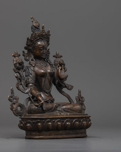 Side angle of White Tara sculpture showing intricate lotus throne