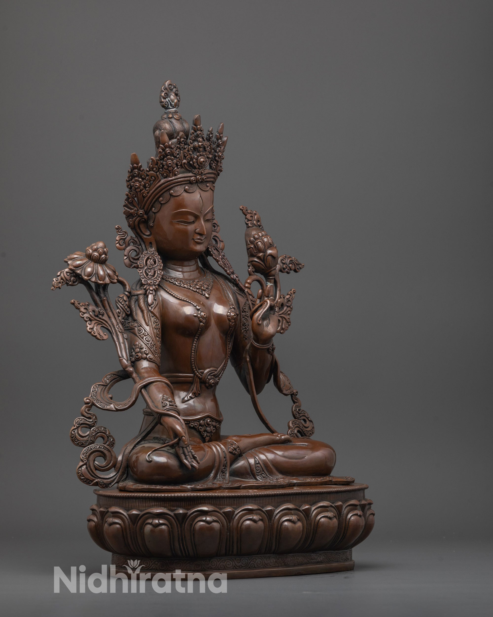 Side angle of White Tara statue highlighting flowing robes and lotus seat details