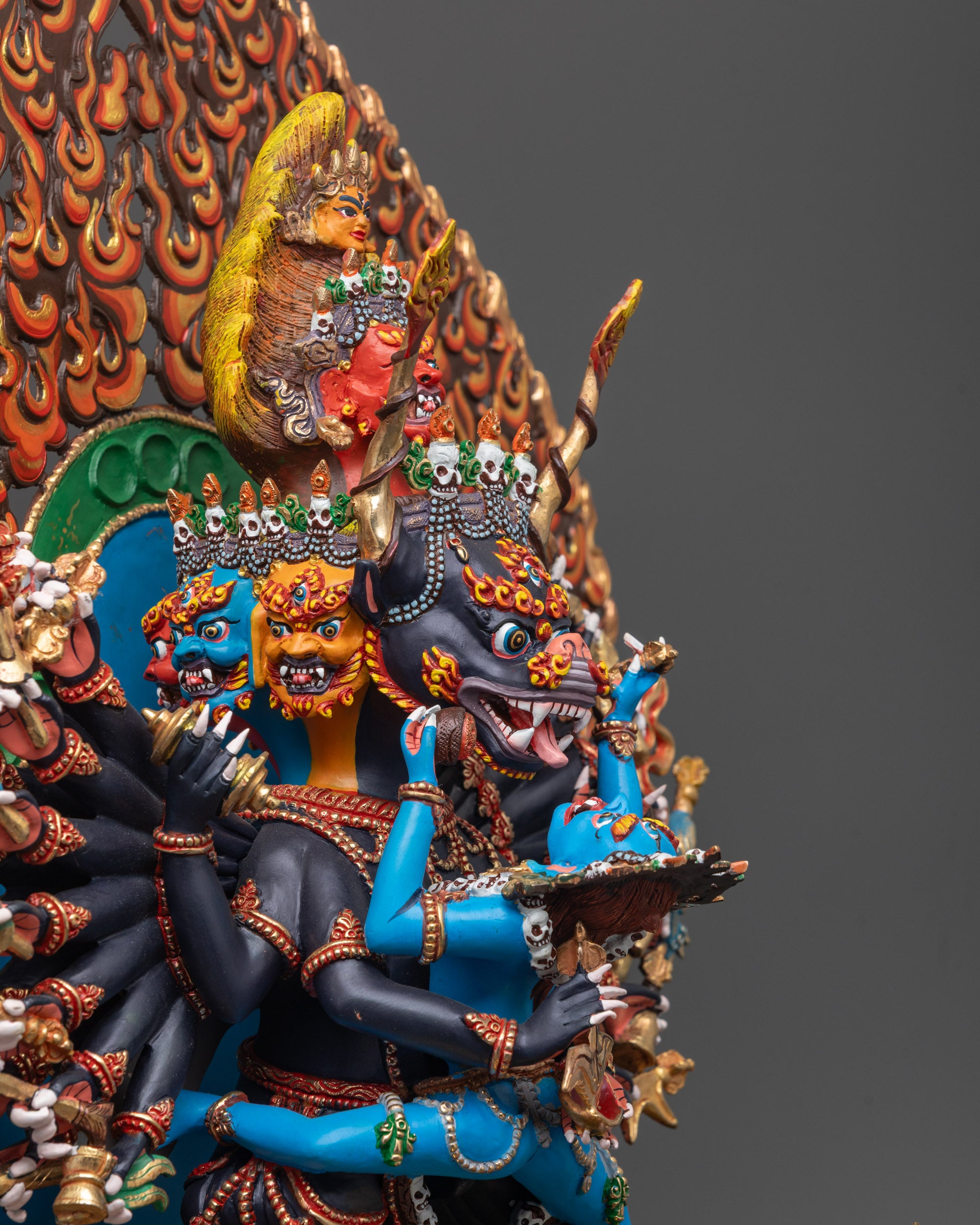 Side angle of black-hued Yamantaka and blue-hued consort with blazing halo details