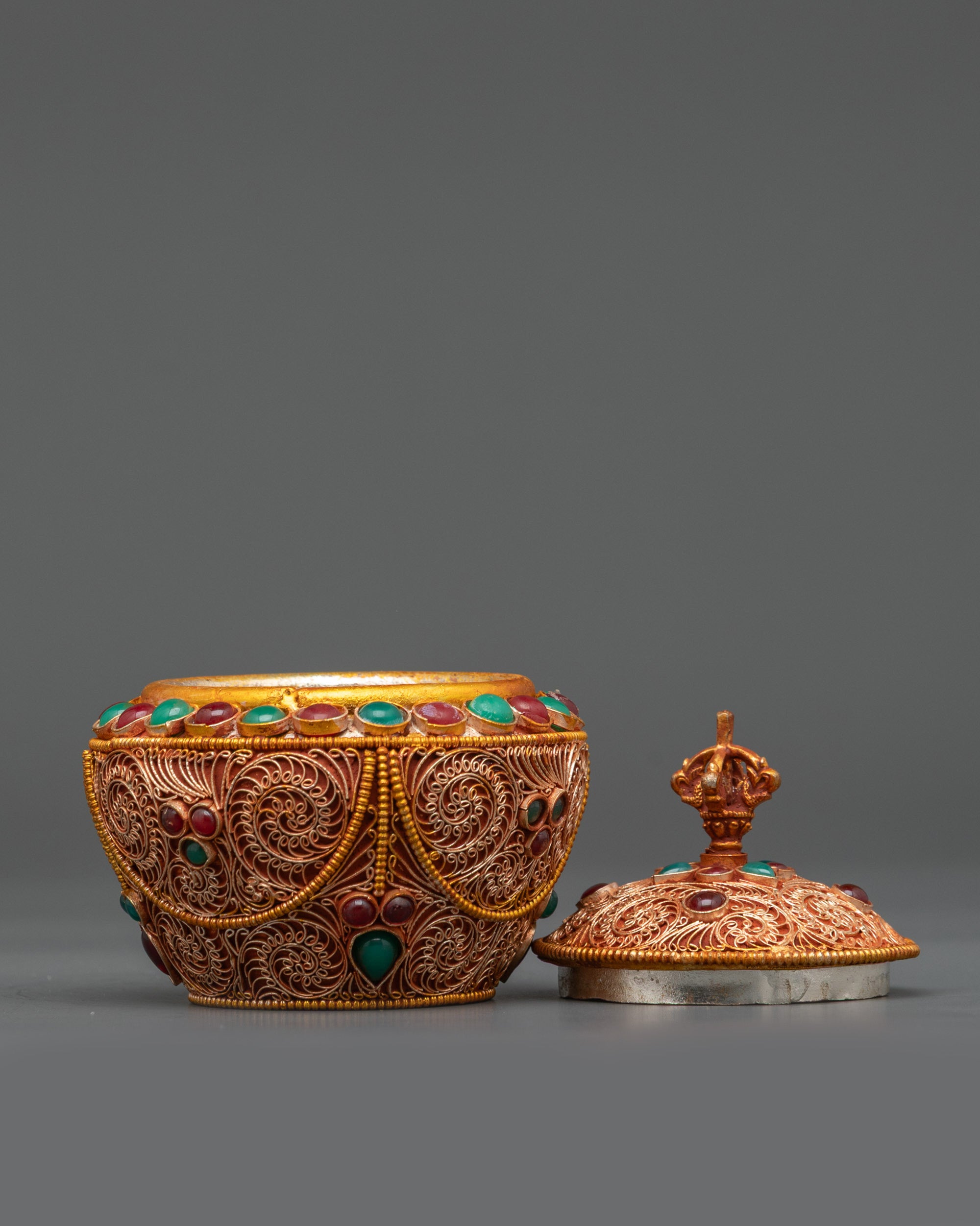 Side angle of copper and gold-plated Gulpa Rice Pot with half vajra handle Nepal