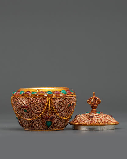 Side angle of copper and gold-plated Gulpa Rice Pot with half vajra handle Nepal