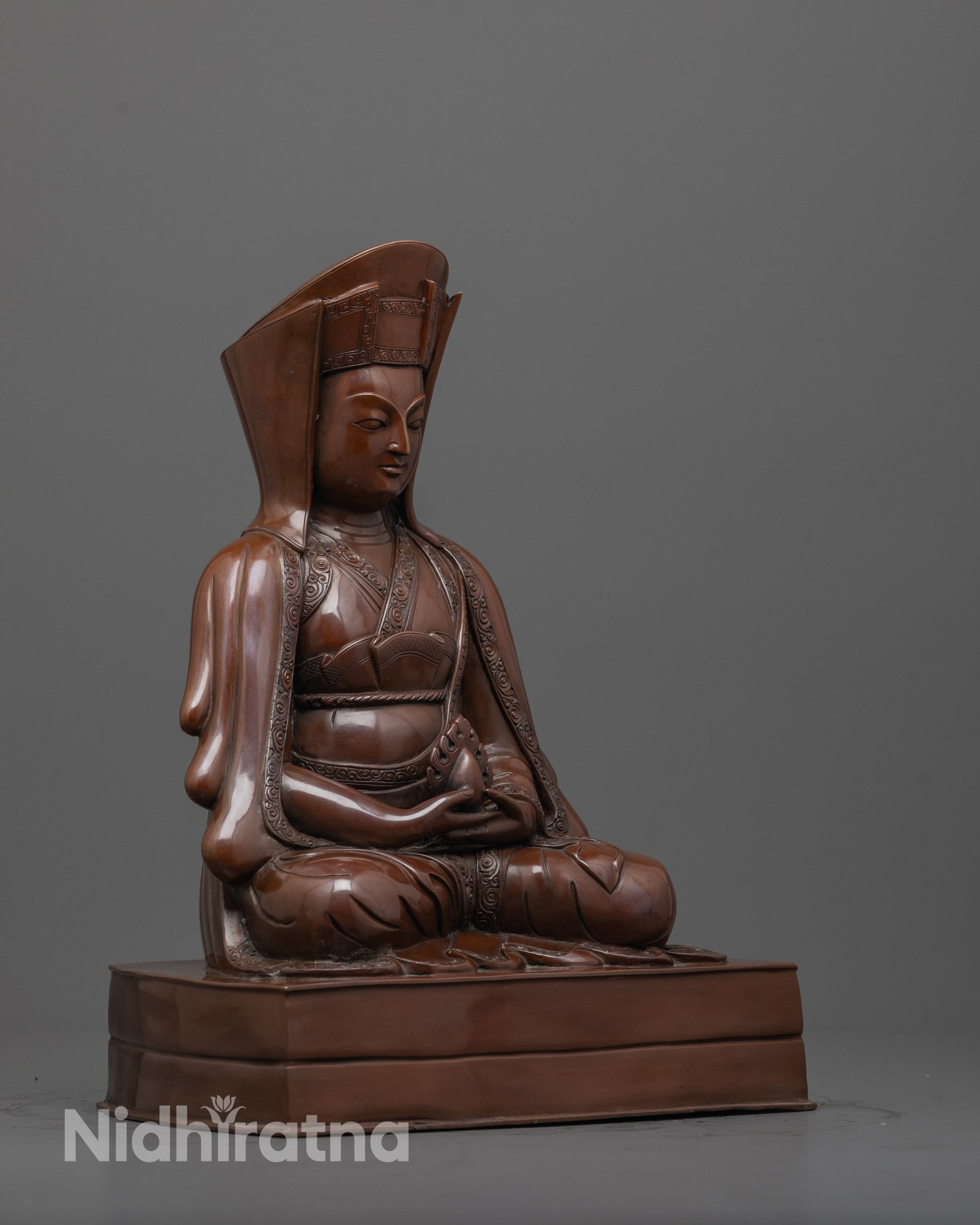 Side angle of earthy-hued Lama Gampopa Statue crafted with lost wax casting technique