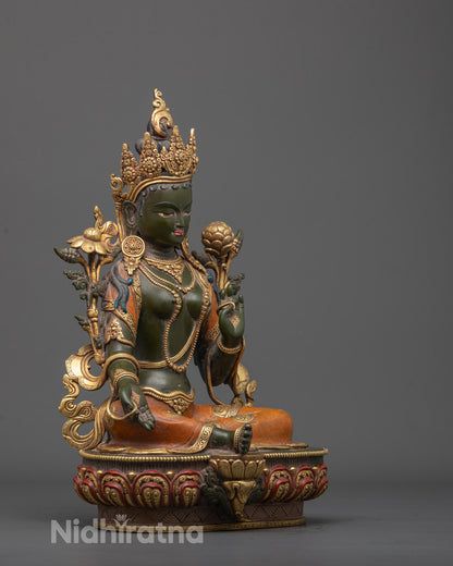 Side angle of hand-carved Green Tara Sculpture with dark green body