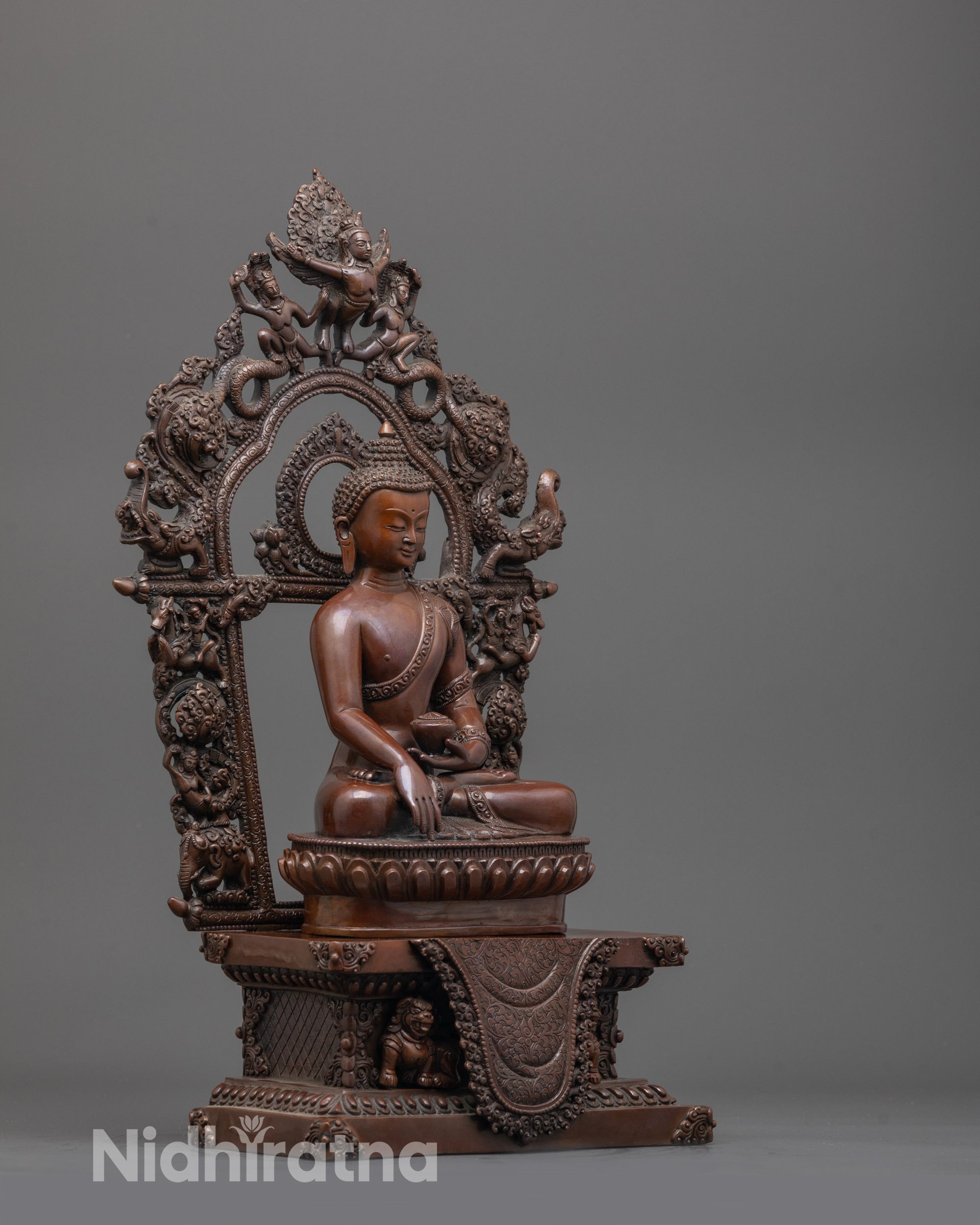 Side angle of hand-carved Shakyamuni Buddha Statue highlighting detailed robe