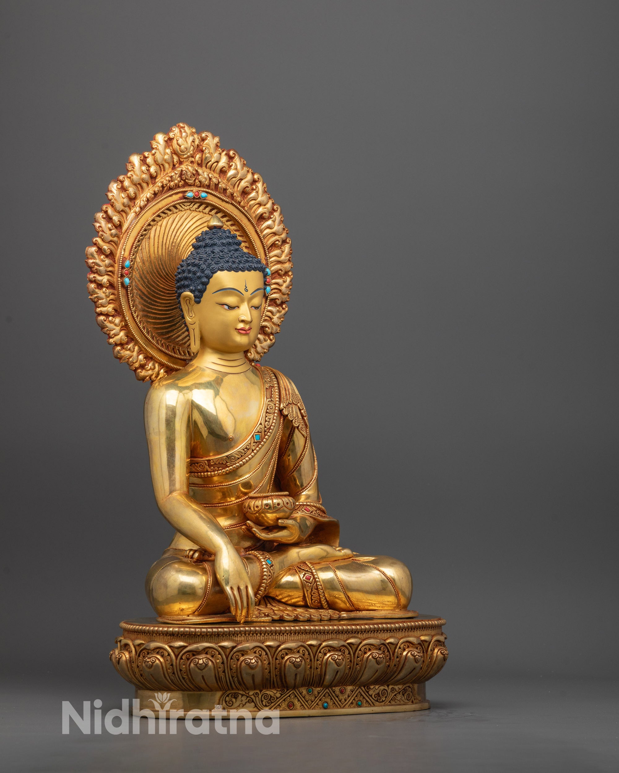 Side angle of hand-carved Shakyamuni Buddha statue showcasing traditional robe folds