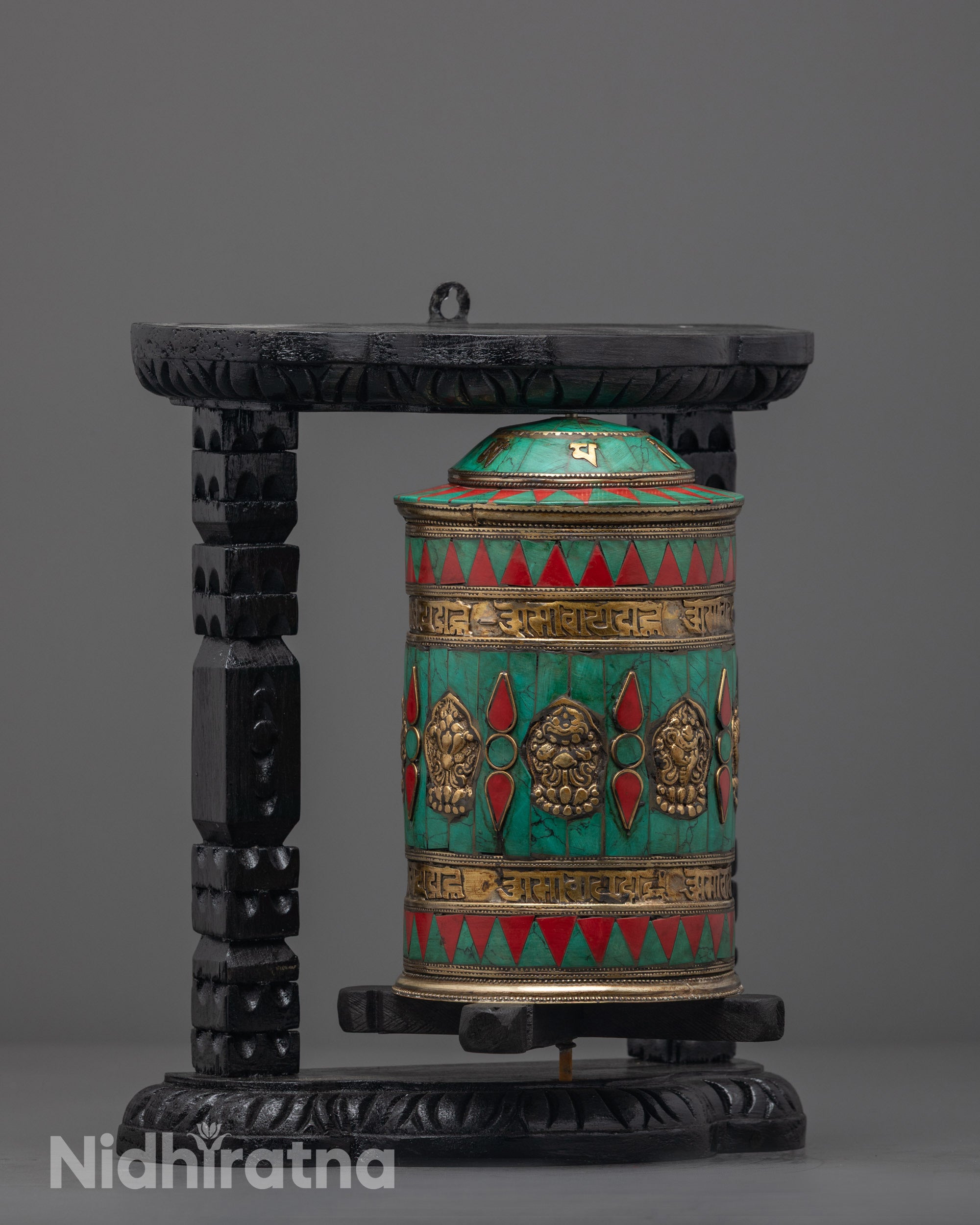 Side angle of handcrafted Auspicious Prayer Wheel featuring eight auspicious symbols and semi-precious stones