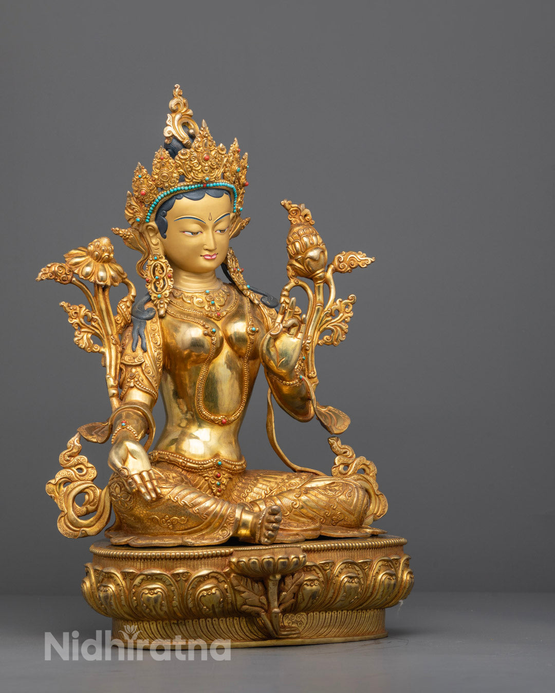 Side angle of handcrafted Mother Tara Statue showing uptala flower and flowing robe


