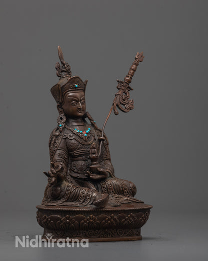 Side angle of handcrafted Padmasambhava Sculpture seated on lotus throne with trident and ornaments