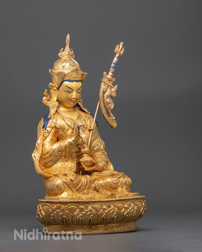 Side angle of handcrafted Padmasambhava statue showing vase, vajra, and trident

