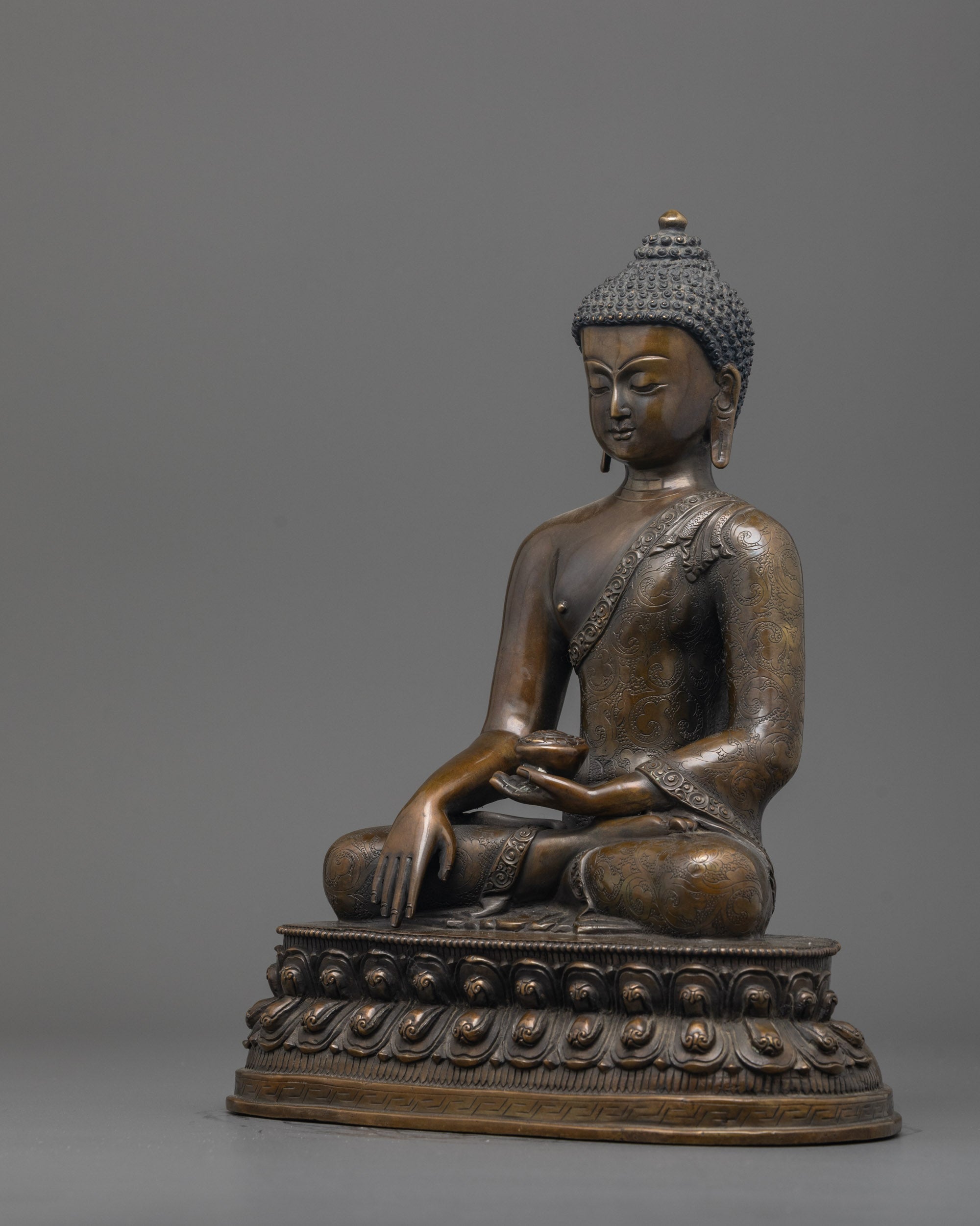 Side angle of handcrafted Shakyamuni Buddha statue in Bhumisparsha mudra on lotus base