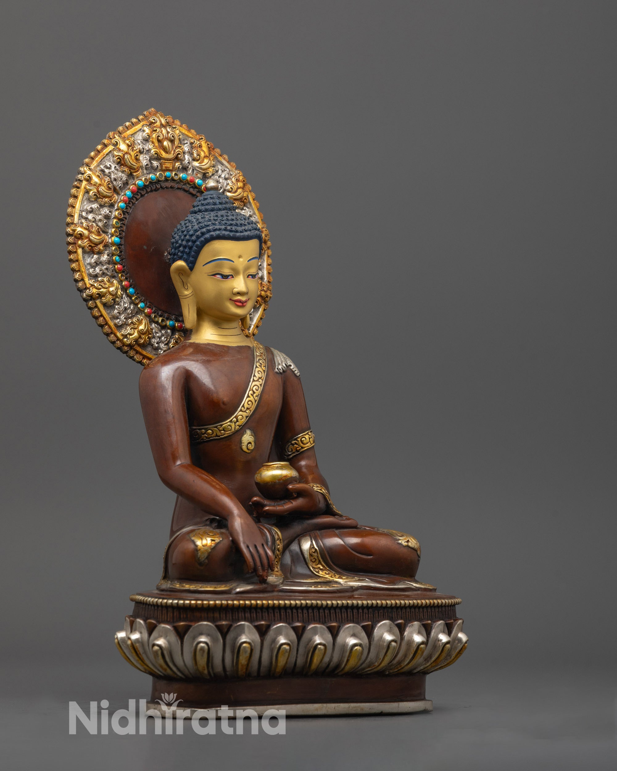 Side angle of handcrafted Shakyamuni Statue seated on lotus-moon disc with semi-precious stone halo
