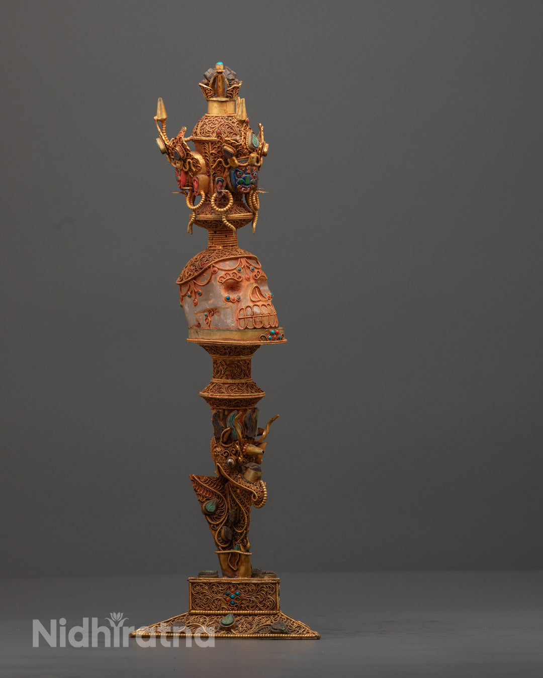 Side angle of handcrafted crystal Phurba showcasing intricate copper and acrylic design