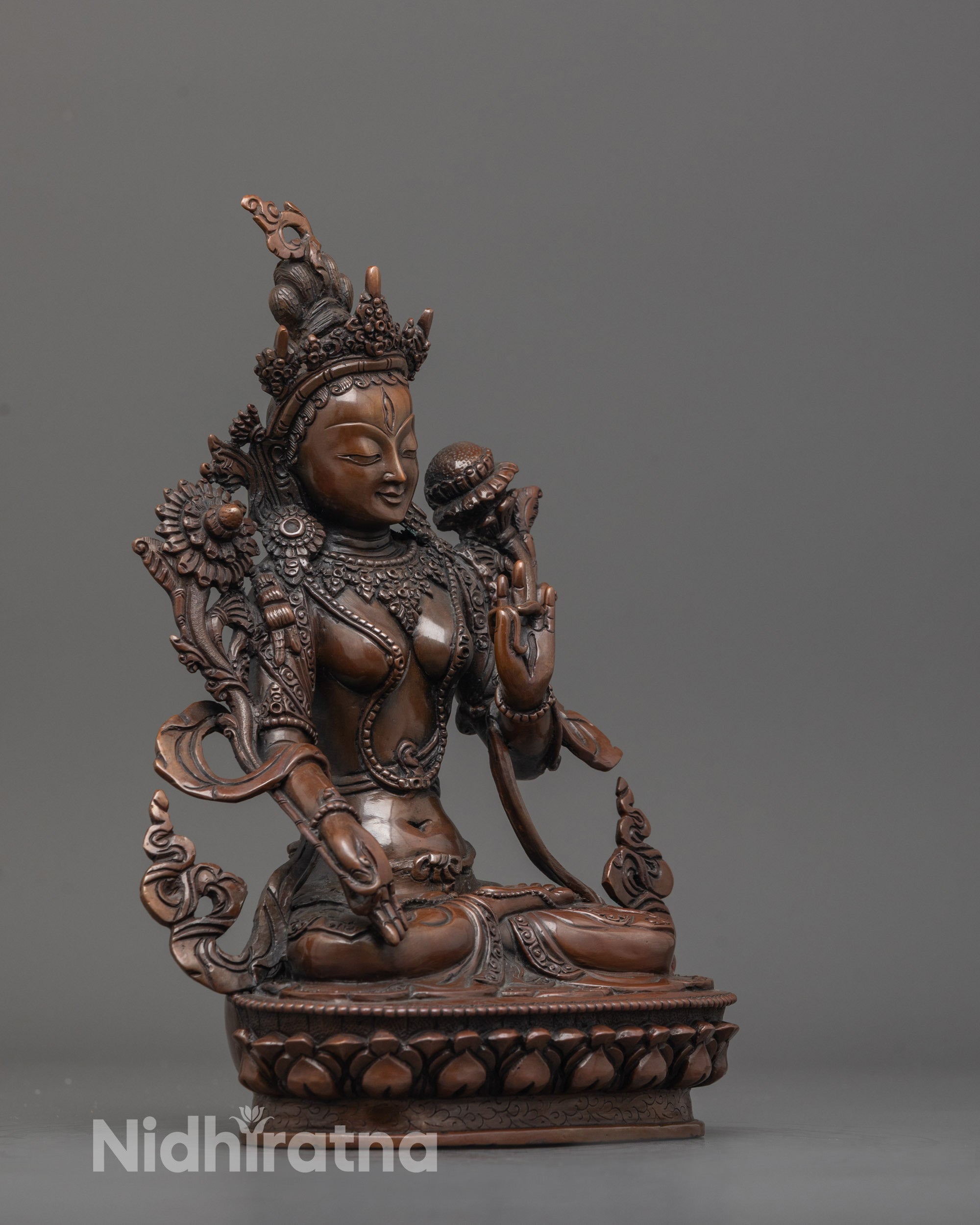 Side angle of handcrafted White Tara statue with seven all-seeing eyes and floral motifs