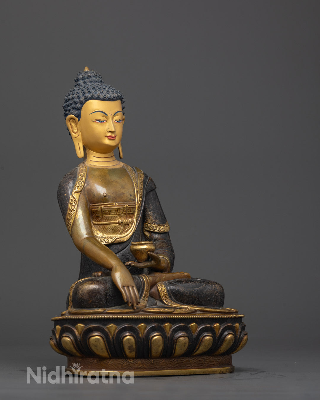 Side angle of handcrafted oxidized copper Shakyamuni Buddha statue on lotus throne