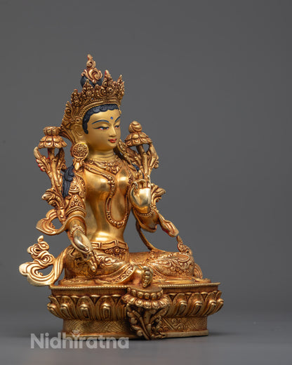 Side angle of handmade Green Tara statue showing flowing robes and ornate jewelry details