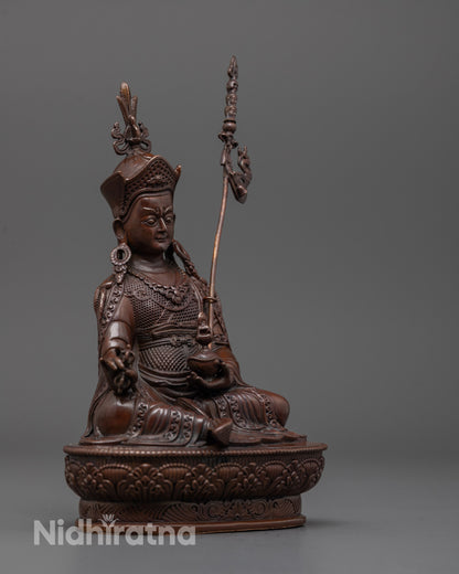 Side angle of machine-made Guru Rinpoche statue with dark electroplated copper finish