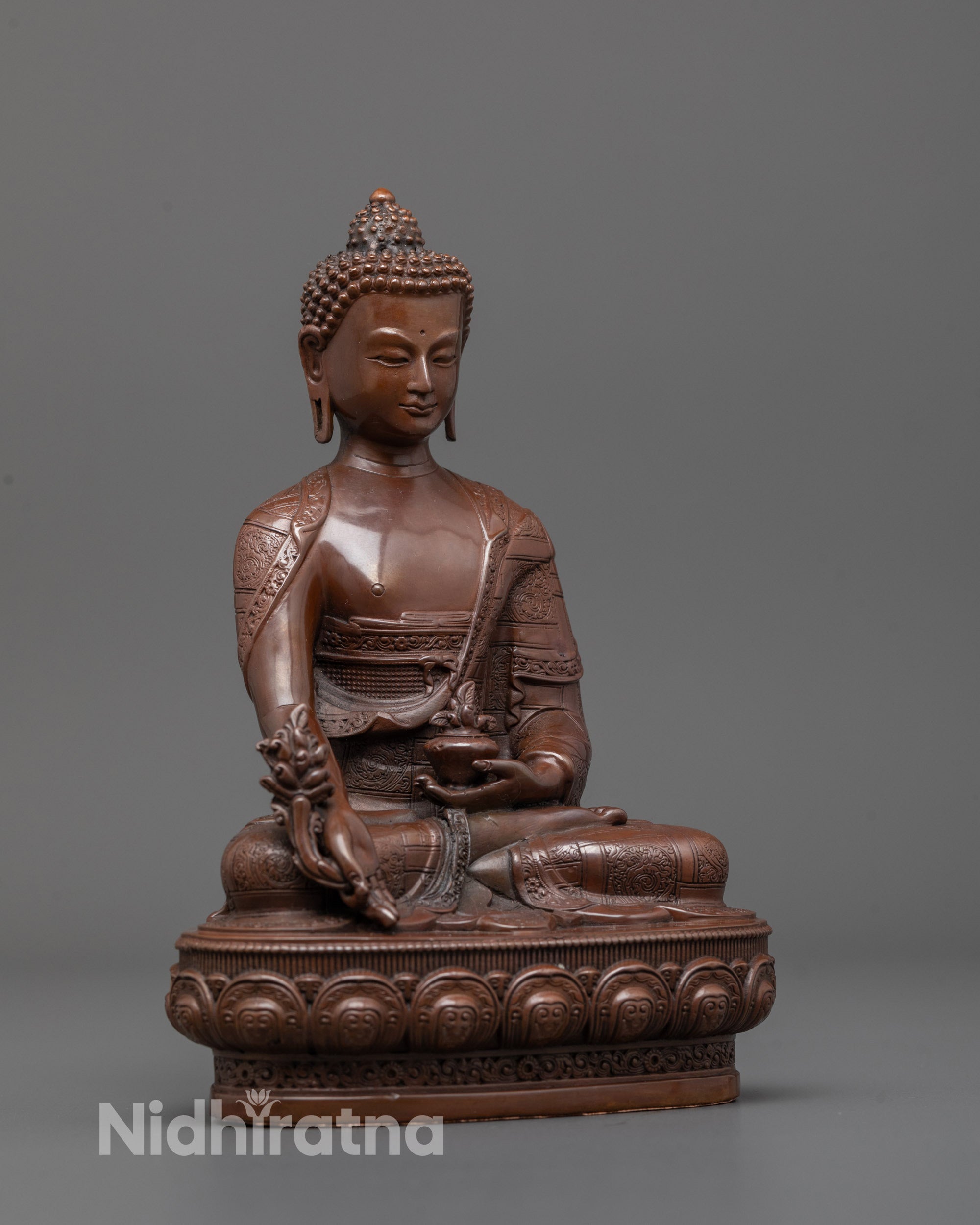 Side angle of machine crafted Medicine Buddha statue polished with gold finish depicting