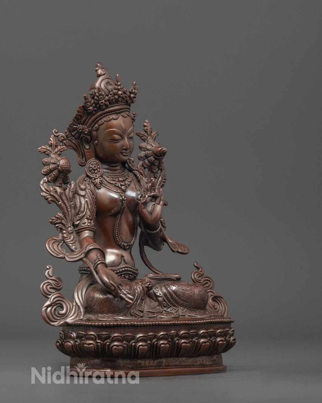 Side angle of oxidized White Tara Mother Drolma statue with Varada and Vitarka Mudra lotus