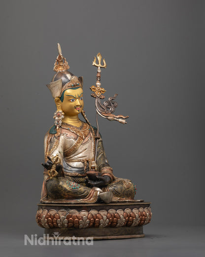 Side angle of oxidized copper Padmasambhava Statue with silver, gold, and copper-plated details